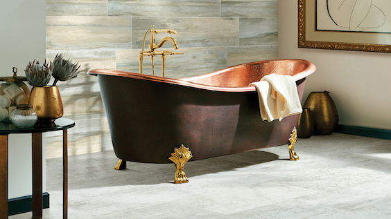 stunning grey tone tile floors in an upscale bathroom with standalone copper tub