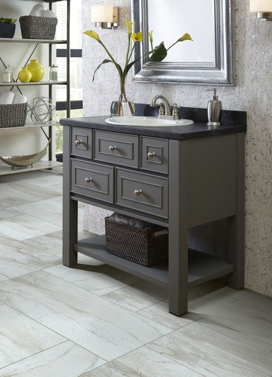 elegant bathroom vanity with grey cabinets and black countertop and tile flooring